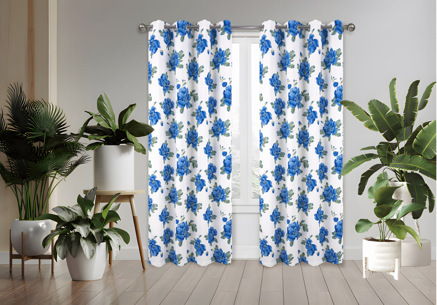 Floral patterned curtains with blue flowers on a white background, placed in a room with plants.