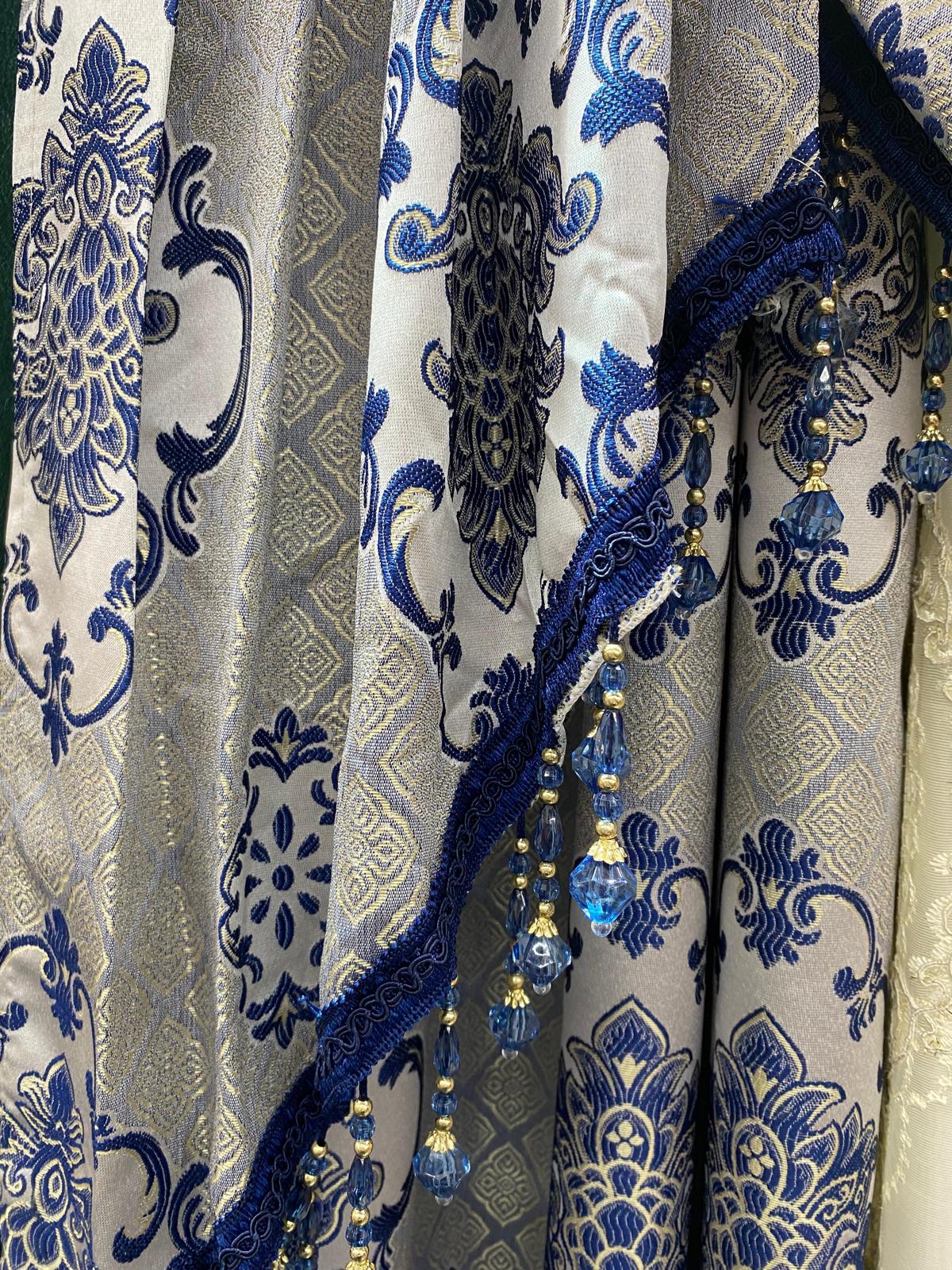 Decorative fabric with blue and gold patterns on a gray background