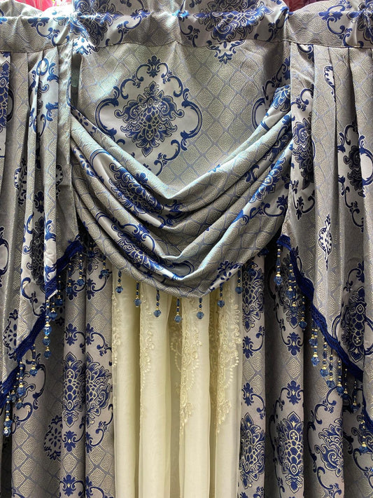 Decorative curtain with floral patterns in blue and beige.