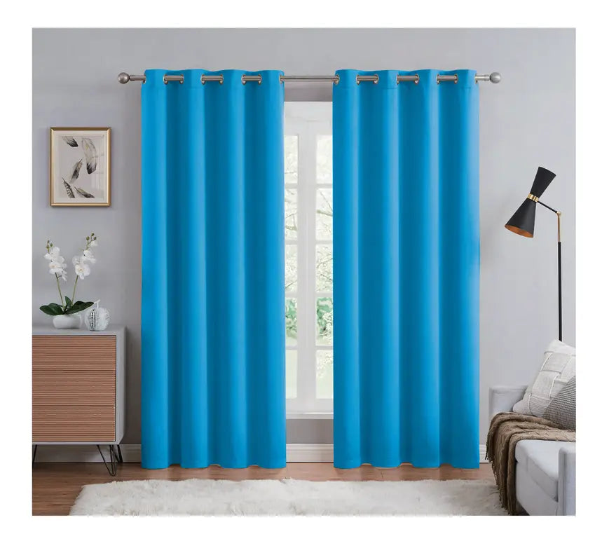 Blue curtains hanging in a room with a window, light gray walls, and minimal decor.