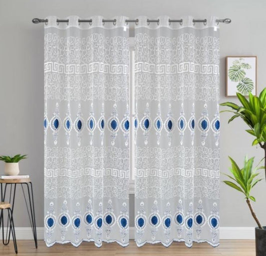 Sheer curtain with blue dot pattern in a room setting